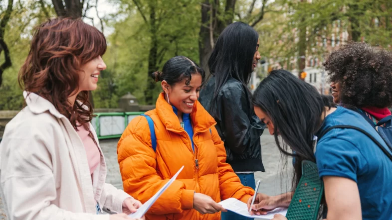 Community organizers gathering signatures for nonprofit formation paperwork during outdoor event