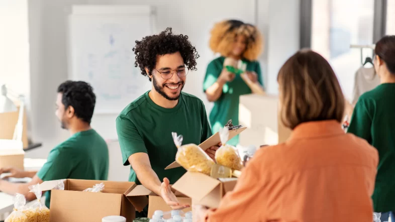 Volunteers managing food bank distribution program during nonprofit startup and launch phase 